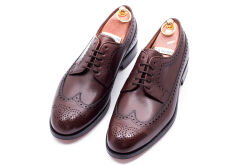 Eleganckie obuwie koloru brązowego typu brogues z skórzaną podeszwą. Szyte metodą ramową.